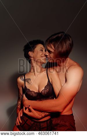 man kissing woman breast